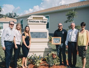 Group-photo-around-FineMark-Village sign