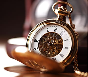 Gold pocket watch and hourglass