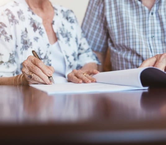 senior-couple-signing-documents