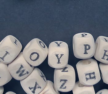 Word Word of small white cubes on a dark background