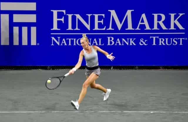 Female tennis player hitting ball