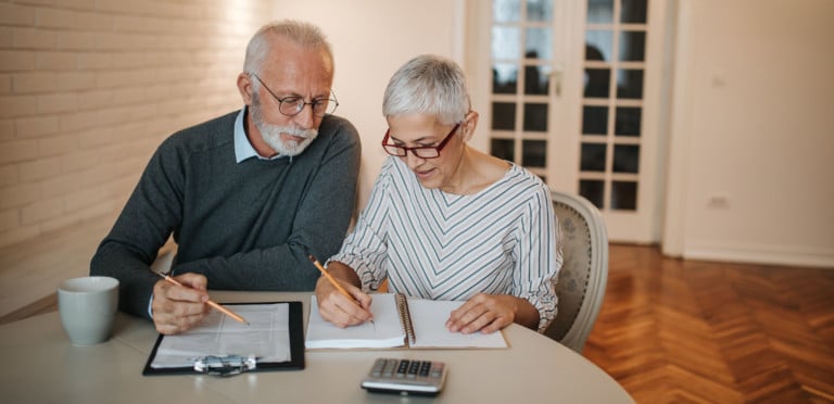A senior couple taking a closer look at their budget in the comfort of their home