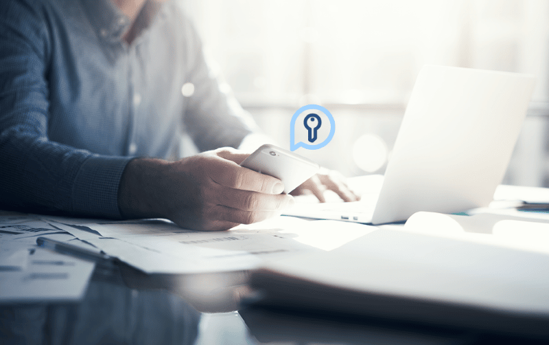 Businessman working with generic design notebook. Holding smartphone in hands