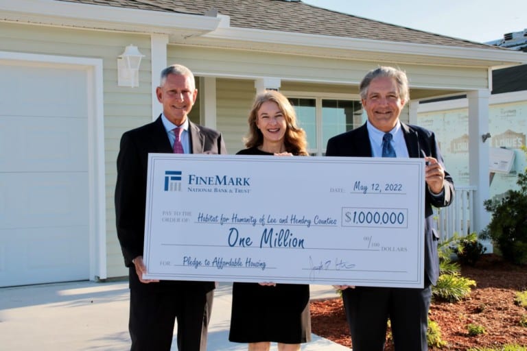 Joe, Becky, Robert holding $1M Check