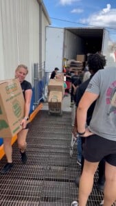 Group carrying boxes of supplies