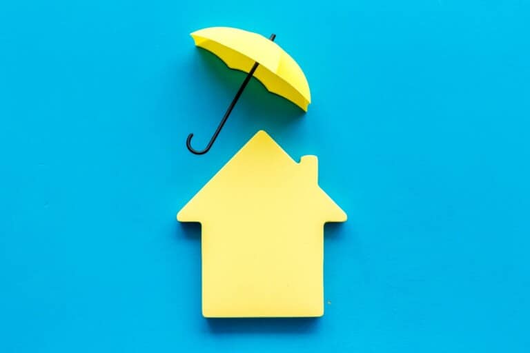 Toy house defended by umbrella