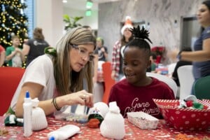 Woman and child building a snowman craft