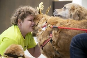 girl hugging golden retriever