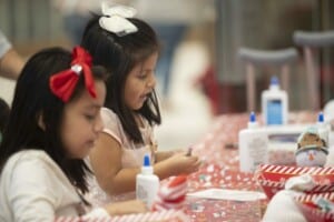 two girls building Christmas crafts