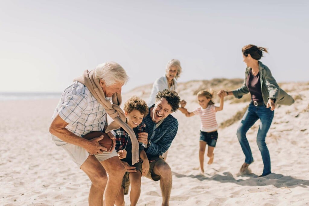 generational family playing on beach