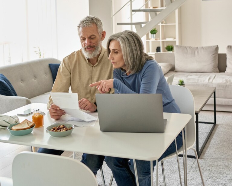 Couple reviewing papers during morning breakfast