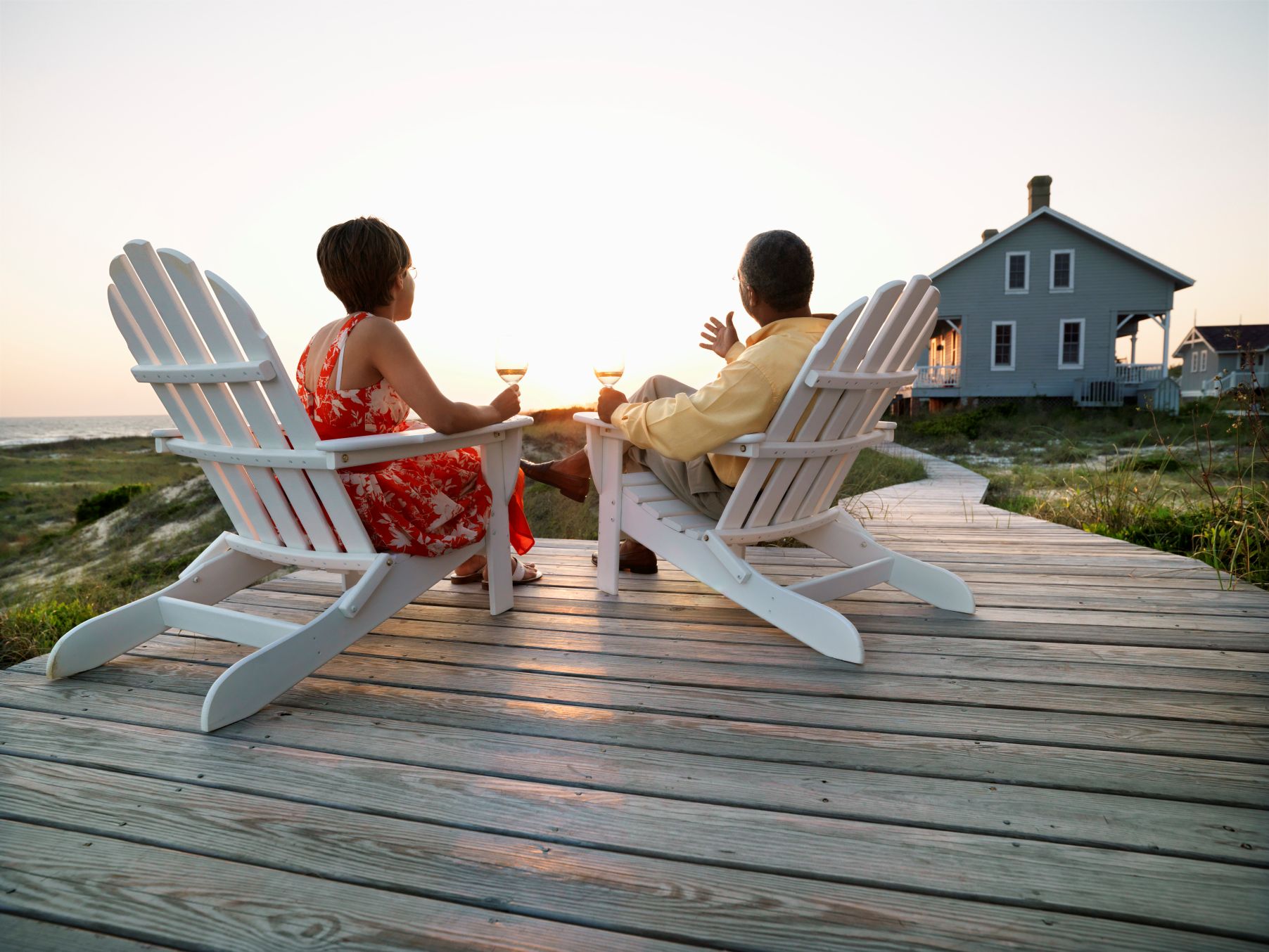 Couple sitting on porch in front of beach out